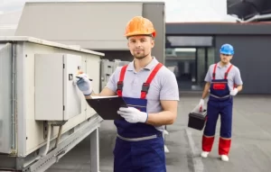 inspectors checking power supply as part of conveyor system maintenance