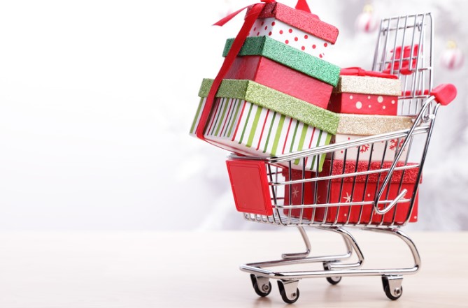 red shopping cart loaded with wrapped Christmas presents