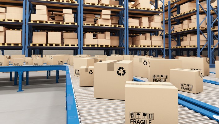 boxes in a warehouse on a blue conveyor with silver rollers