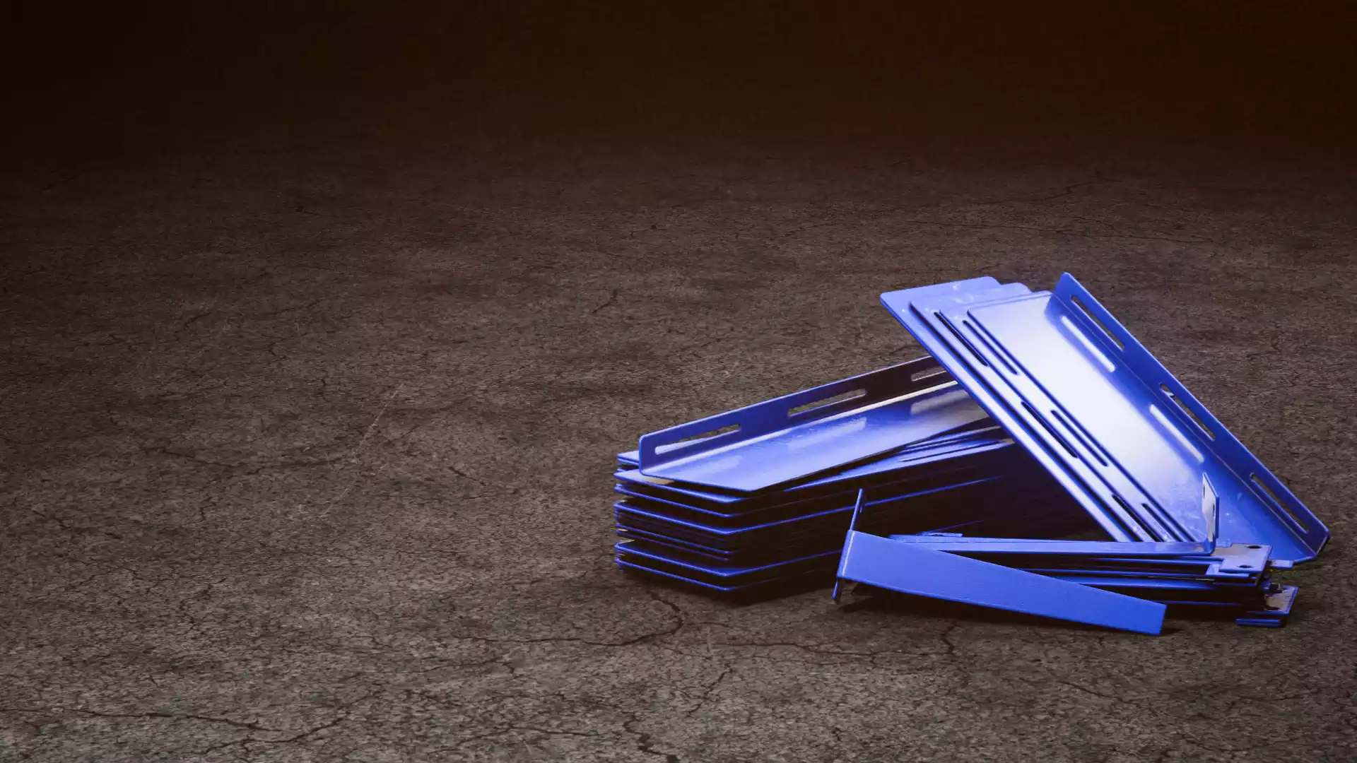 blue conveyor gap plates stacked on a dark grey floor