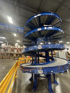 blue spiral conveyor in a warehouse