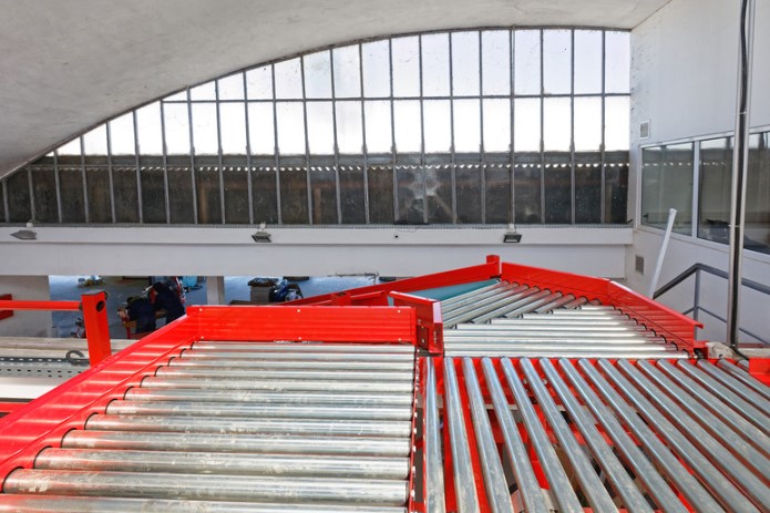 red sortation conveyor in a warehouse