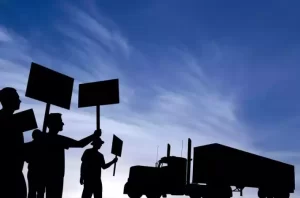 union workers in front of a truck striking about automation in logistics